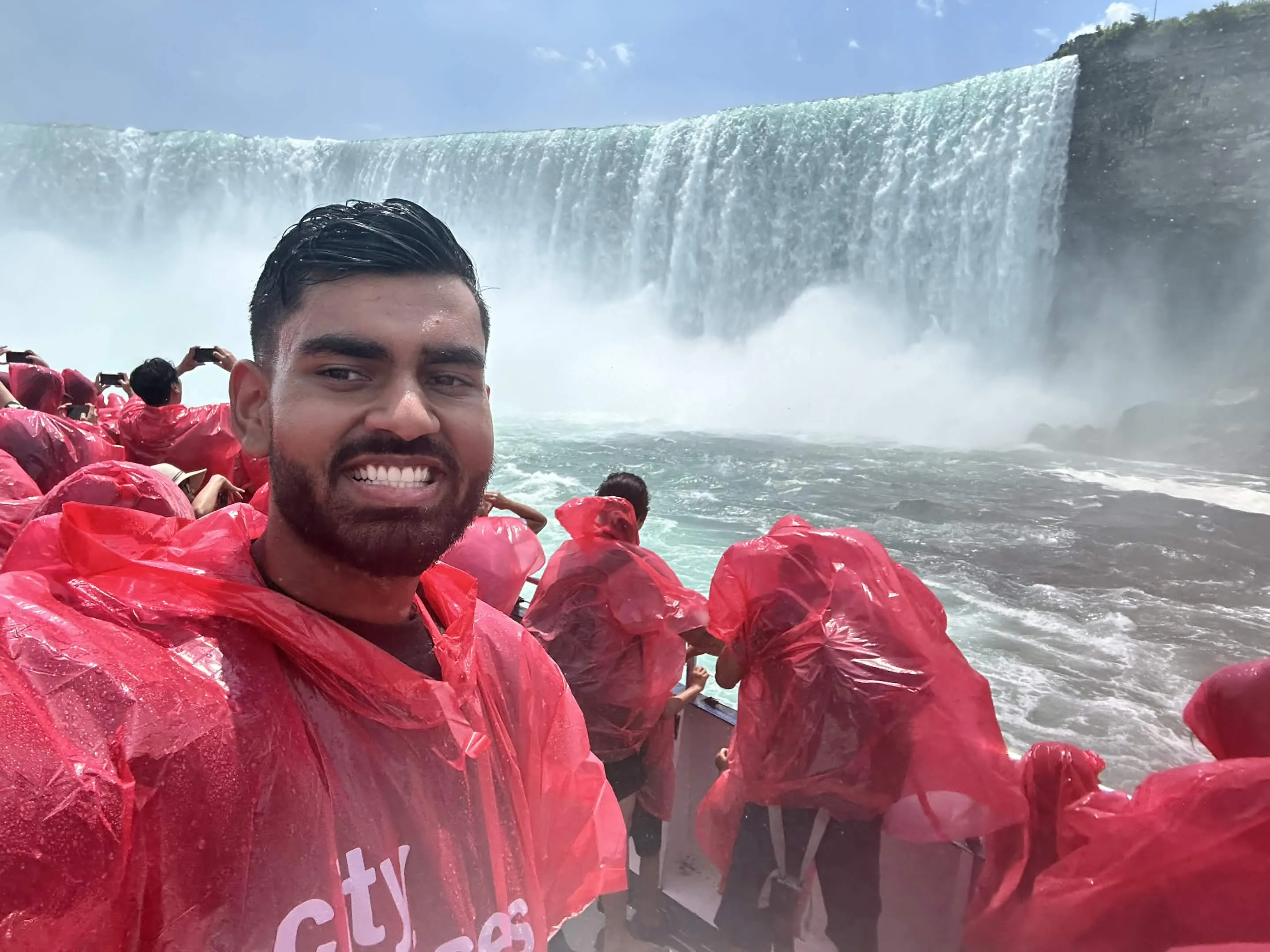 Selfie in a red poncho in front of Horseshoe Falls