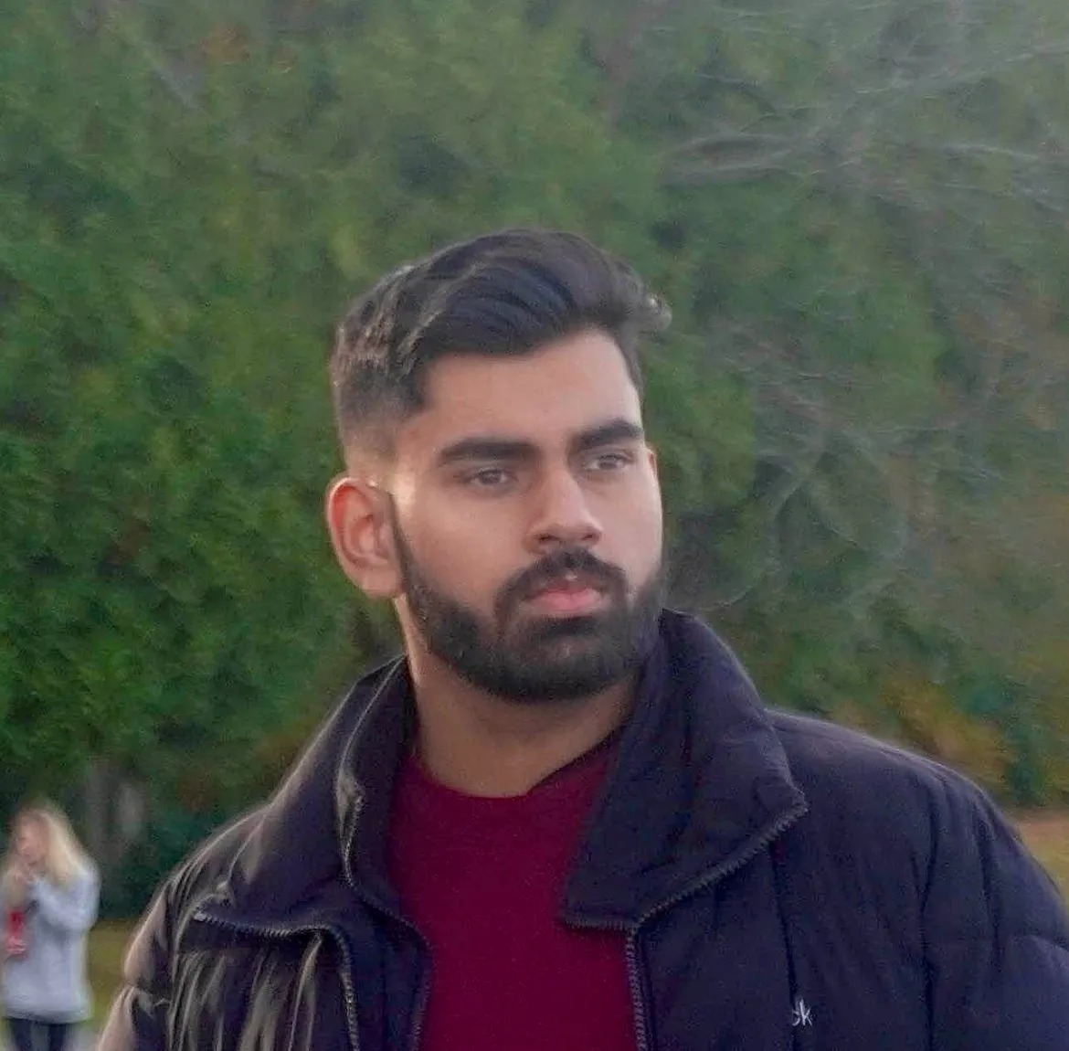Portrait in a navy jacket and maroon sweater