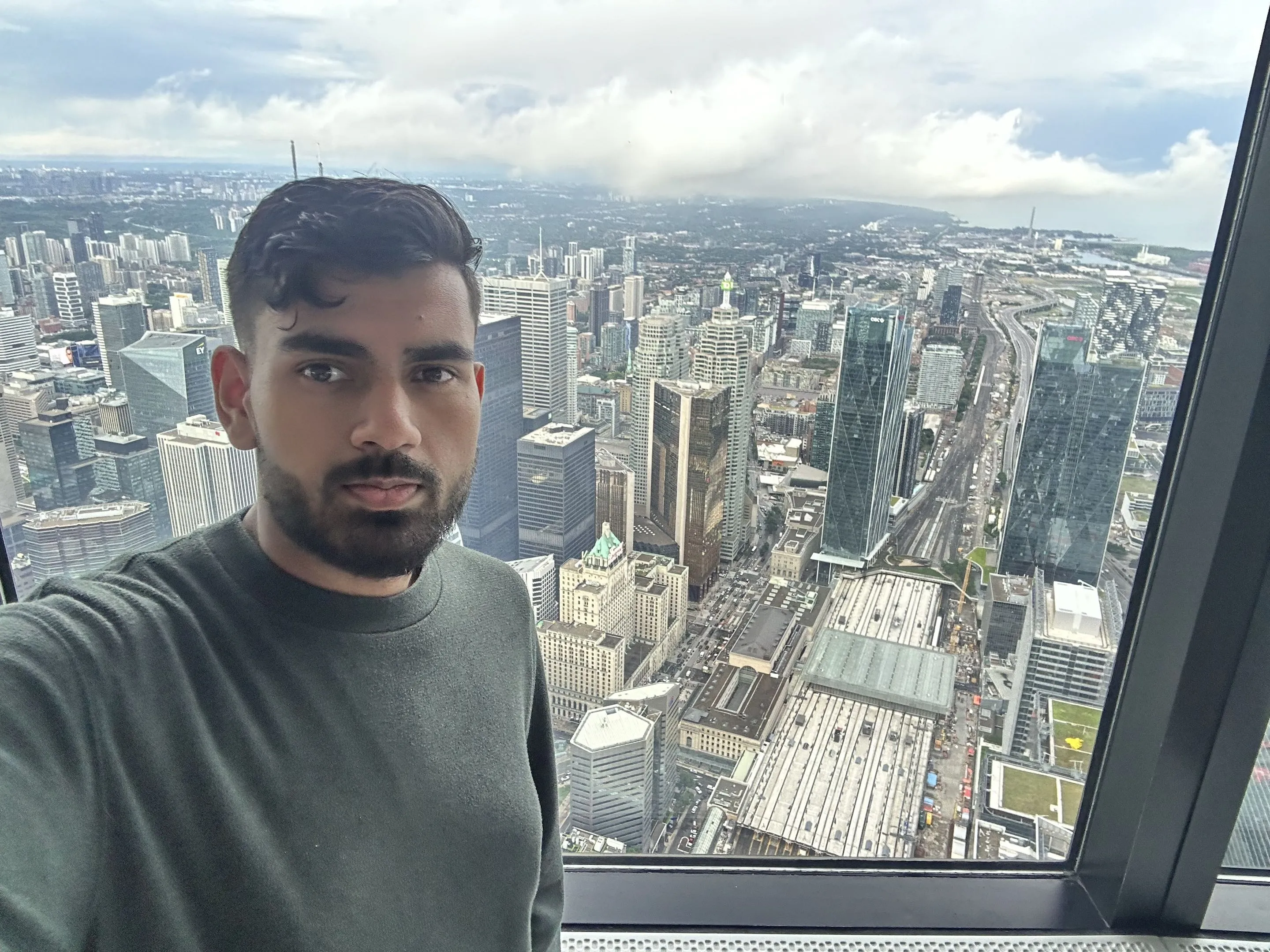 Selfie in front of a window high above the Toronto skyline